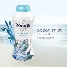 Downy Light Ocean Mist liquid fabric softener bottle with Downy Ocean Mist scent booster beads